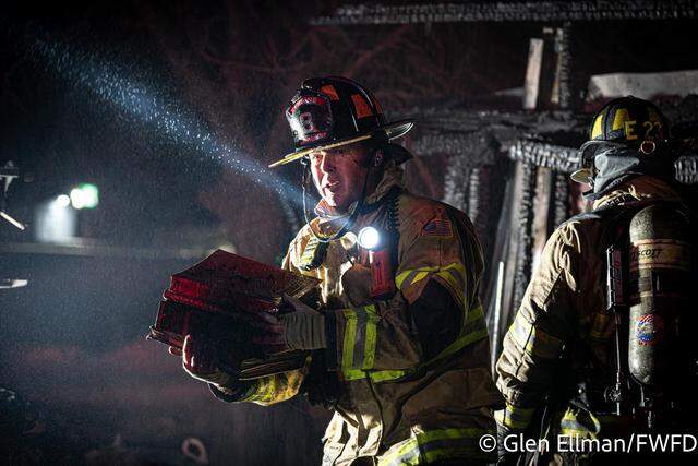 Firefighters salvaged photo albums and other keepsakes from a west Fort Worth outbuilding that was destroyed by flames early Friday, March 13.